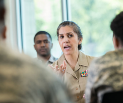 Female military member talking to troops Female military member talking to troops